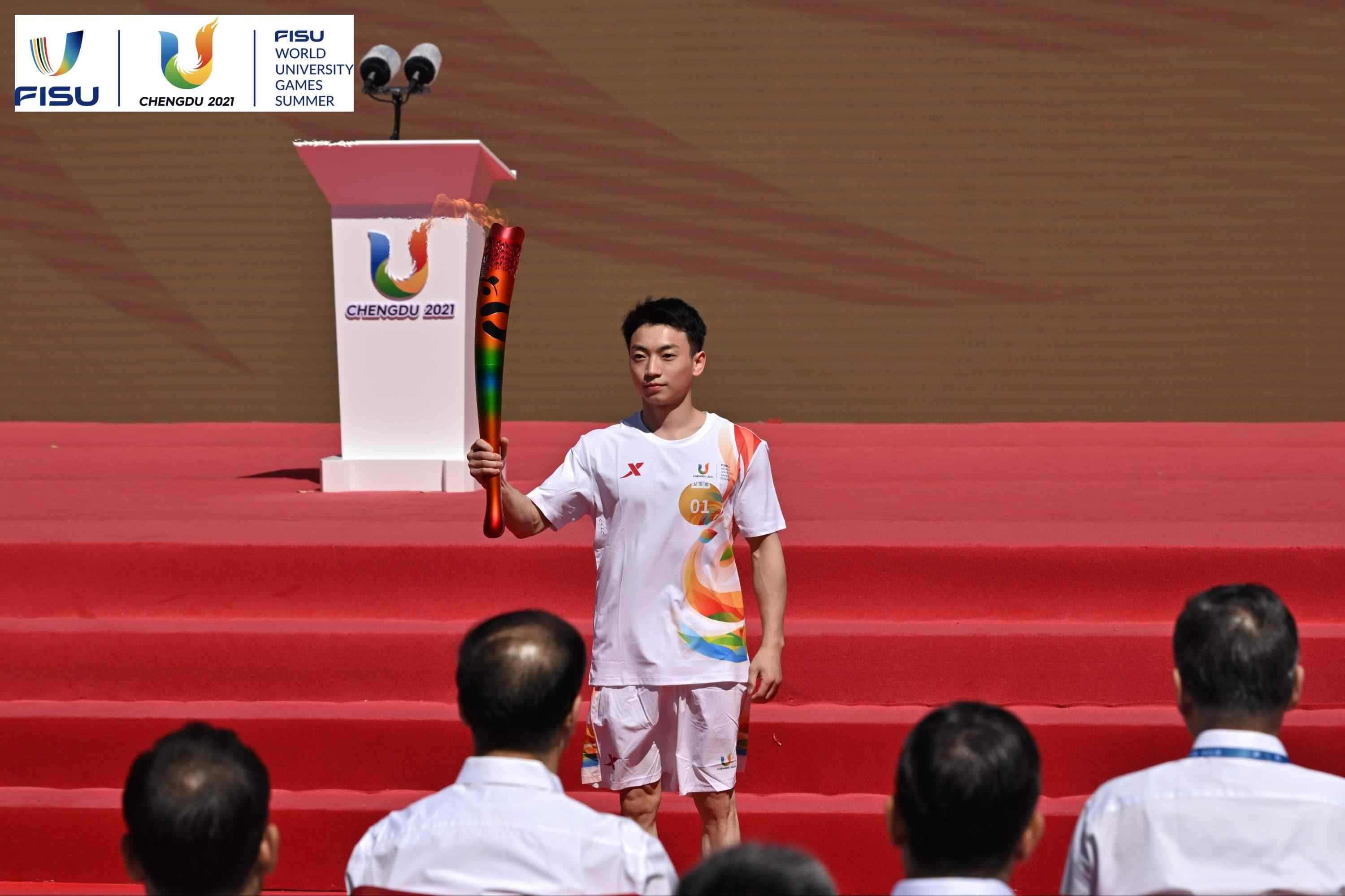 成都大運會火炬手、奧運冠軍鄒敬園高舉火炬。 圖片來源：成都大運會執(zhí)委會供圖