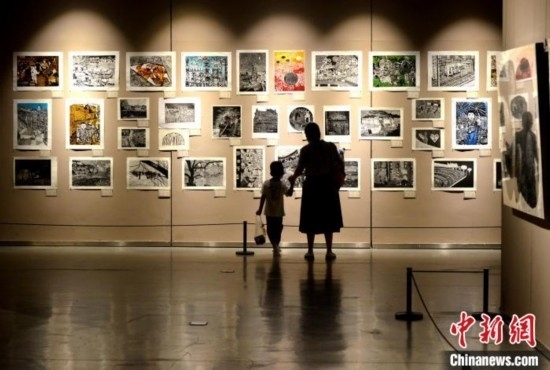 圖為家長帶著孩子參觀展覽。呂明 攝