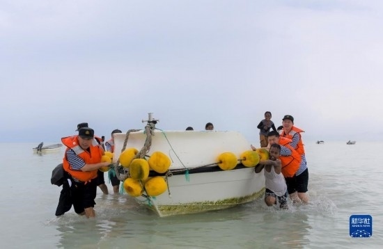 7月21日，中國(guó)海軍“和平方舟”號(hào)醫(yī)院船醫(yī)護(hù)人員涉水登島，前往基里巴斯一診療點(diǎn)。新華社記者 黎云 攝
