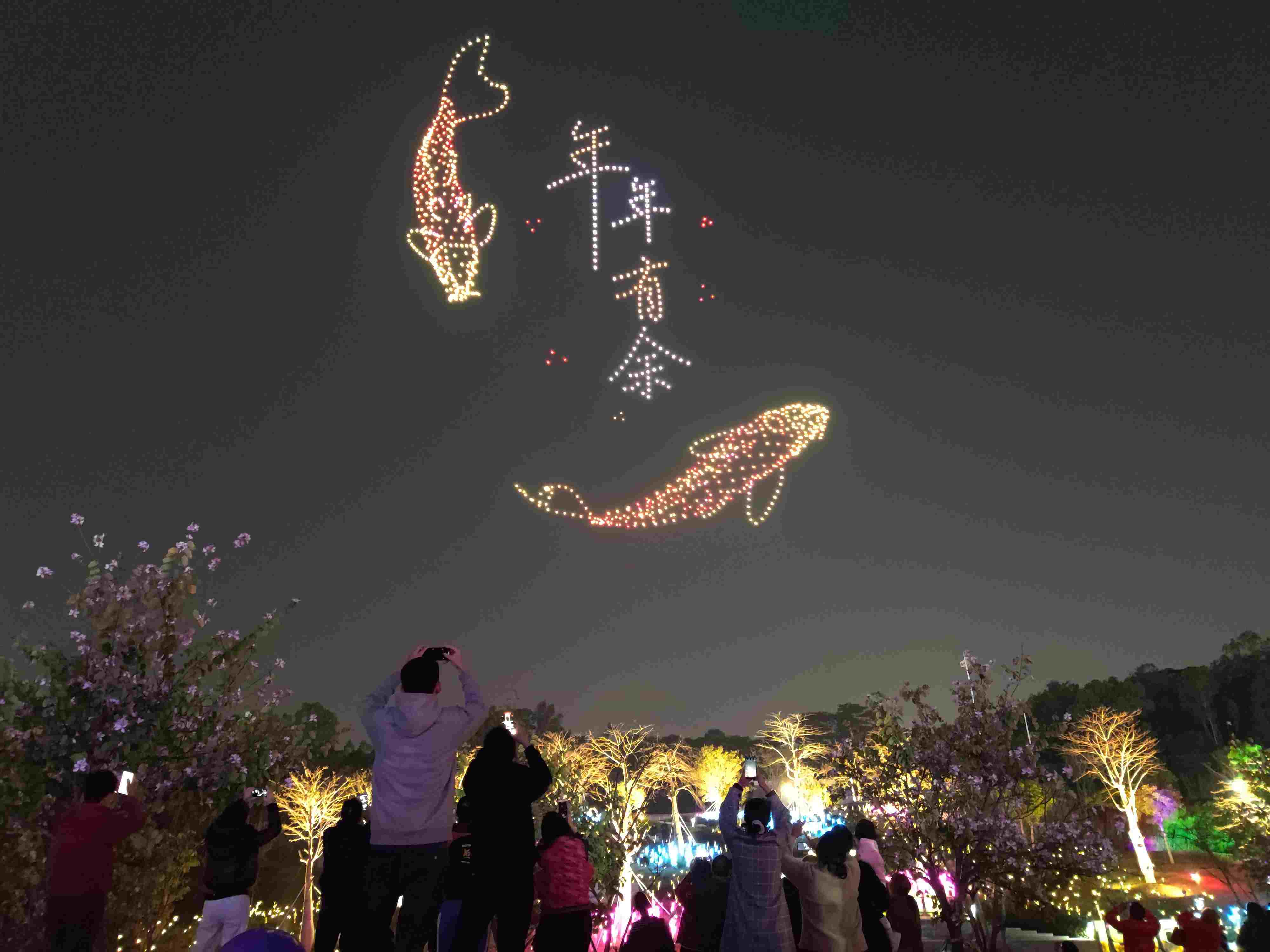 △ 2024年2月10日，深圳北站中心公園，春節(jié)主題無(wú)人機(jī)燈光秀引來(lái)眾多游客駐足觀看。