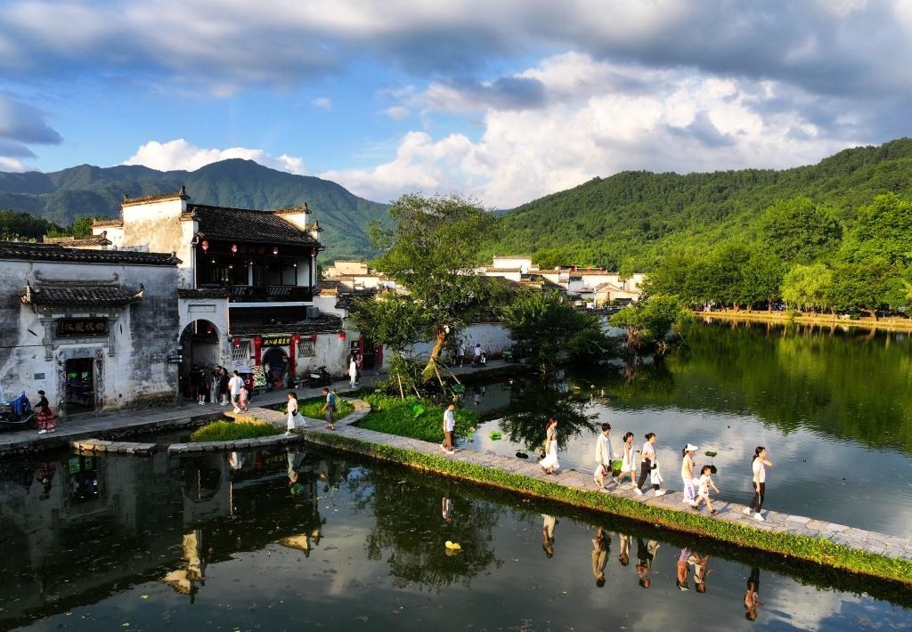 2024年7月7日，游客在安徽省黃山市黟縣宏村游玩。新華社記者杜宇攝