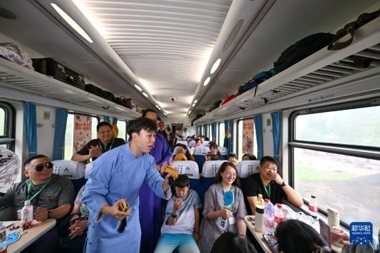 9月7日，相聲演員在S910列車上為旅客表演快板。