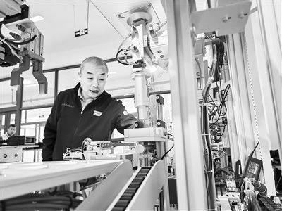 郭海青在檢查車床加工設(shè)備。 受訪者供圖