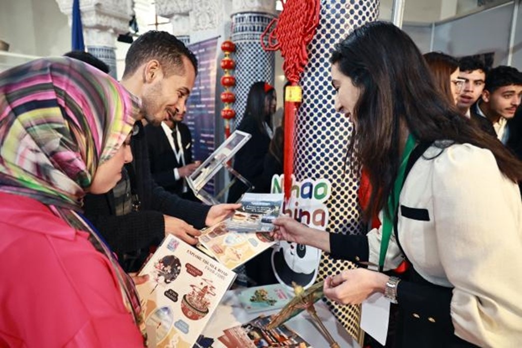 摩洛哥觀眾在中國展臺前觀看宣傳資料。拉巴特中國文化中心供圖