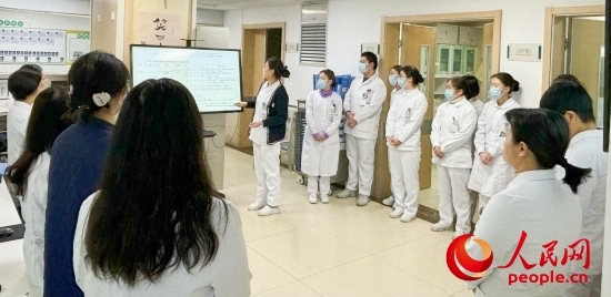 華西第四醫(yī)院姑息醫(yī)學科交班會上，護士介紹患者情況。人民網(wǎng)記者 金慧慧攝