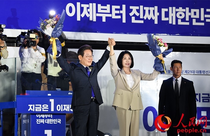 6月4日凌晨，確定當(dāng)選韓國總統(tǒng)的李在明舉手向歡呼的支持者們致意。 人民網(wǎng) 康炯彬攝